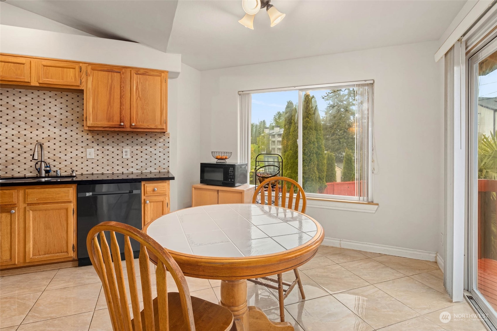 9031 West Mall Drive Everett, WA 98208 - Photo 15 of 32 a view of a dining room with a table and chairs