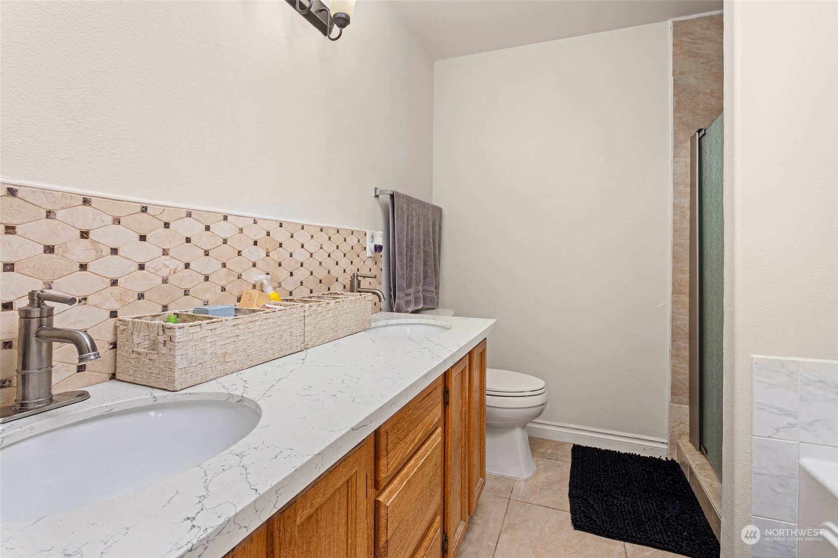 9031 West Mall Drive Everett, WA 98208 - Photo 22 of 32 a bathroom with a sink toilet and vanity