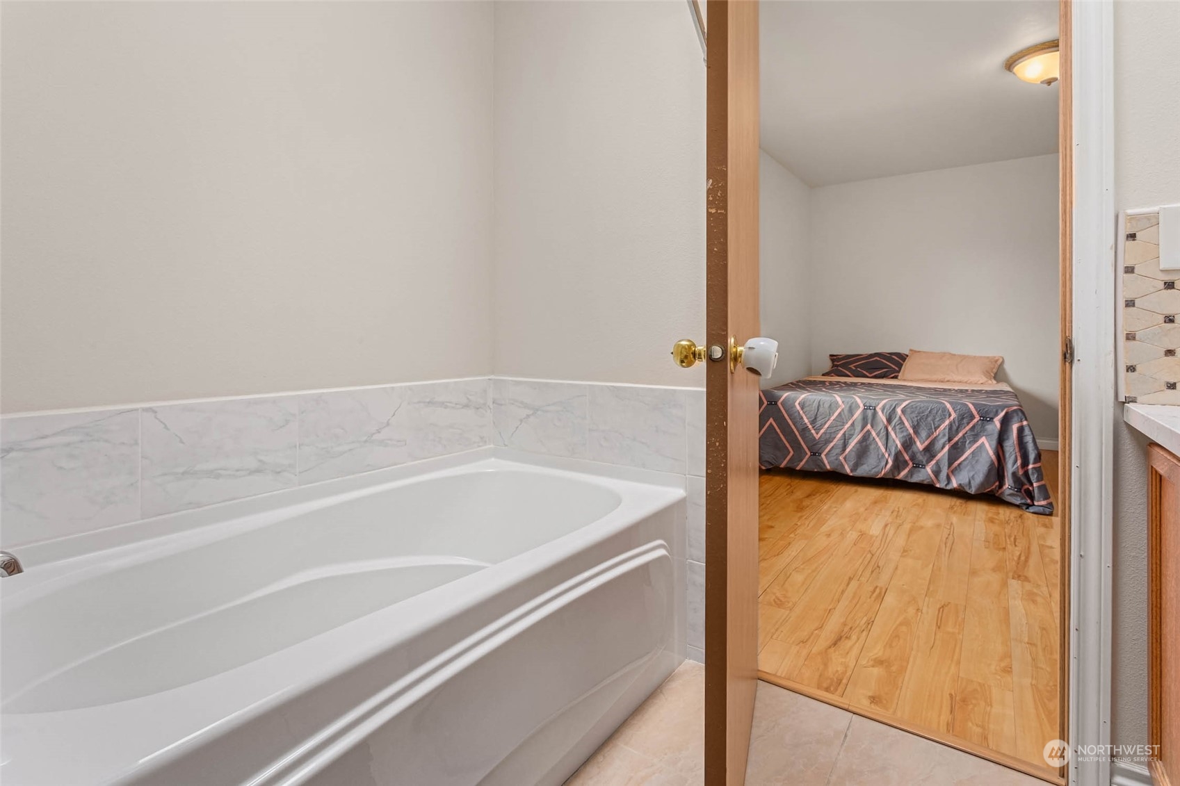 9031 West Mall Drive Everett, WA 98208 - Photo 23 of 32 a bathroom with a tub and a bed