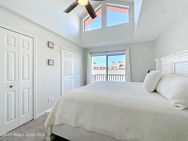 a bedroom with a large bed and a window