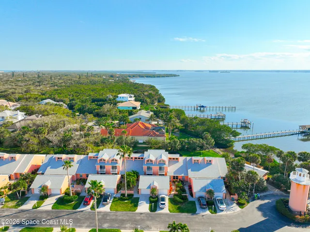 an aerial view of a houses with a swimming pool