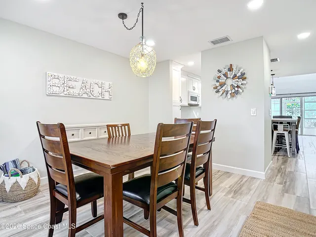 a view of a dining room with furniture wooden floor and chandelier