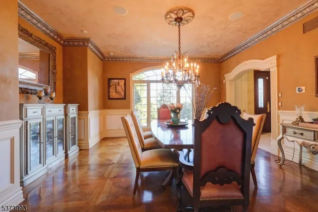 a view of a dining room with furniture wooden floor and chandelier