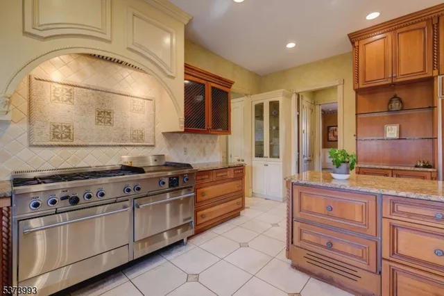 a kitchen with stainless steel appliances granite countertop a stove and a refrigerator