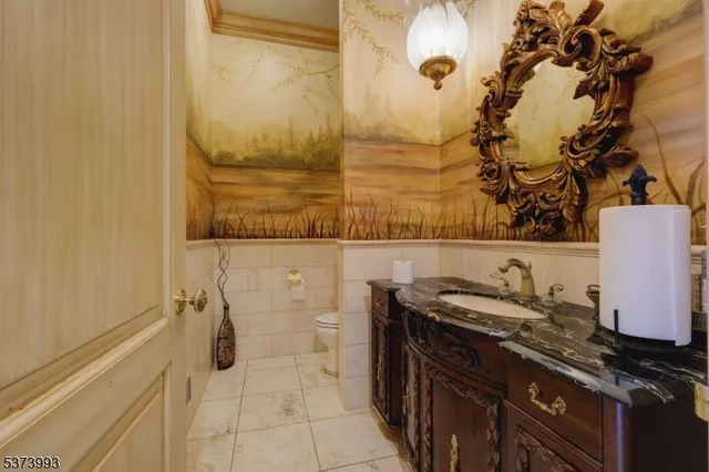 a bathroom with a granite countertop sink a mirror and shower
