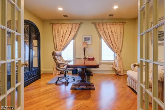 a view of a livingroom with furniture a floor to ceiling window and wooden floor