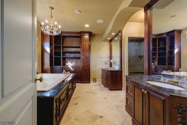 a bathroom with a sink a large mirror and a shower