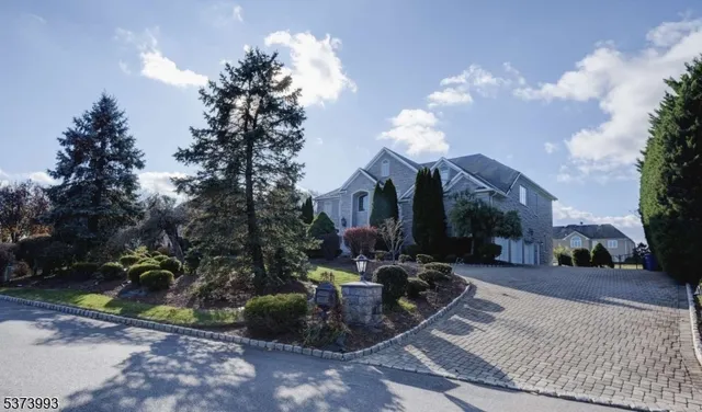 a view of a house with yard and sitting area