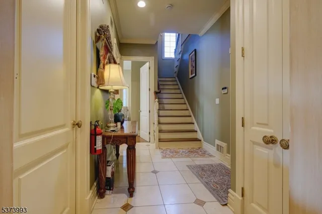a view of a hallway with wooden floor and stairs