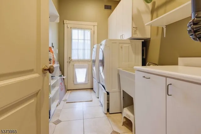 a kitchen with a refrigerator a stove top oven and a granite counter tops