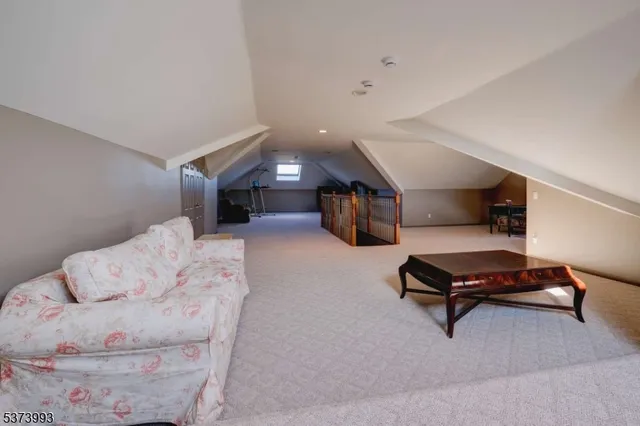 a living room with furniture and a lamp