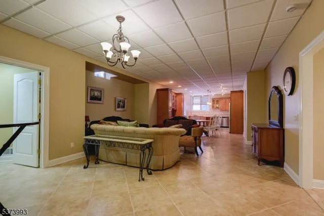 a living room with furniture and a chandelier