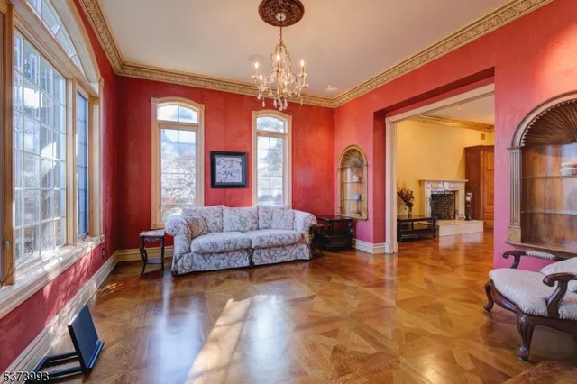 a living room with furniture and a chandelier