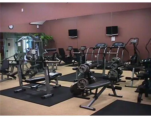 a room with gym equipment and mirror