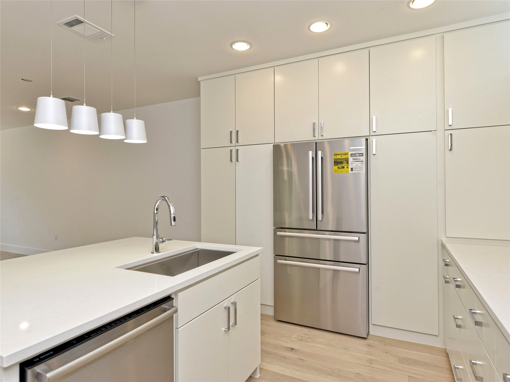 3406 East 17th Street, Unit 3 Austin, TX 78721 - Photo 13 of 27 a kitchen with kitchen island a sink stainless steel appliances and cabinets
