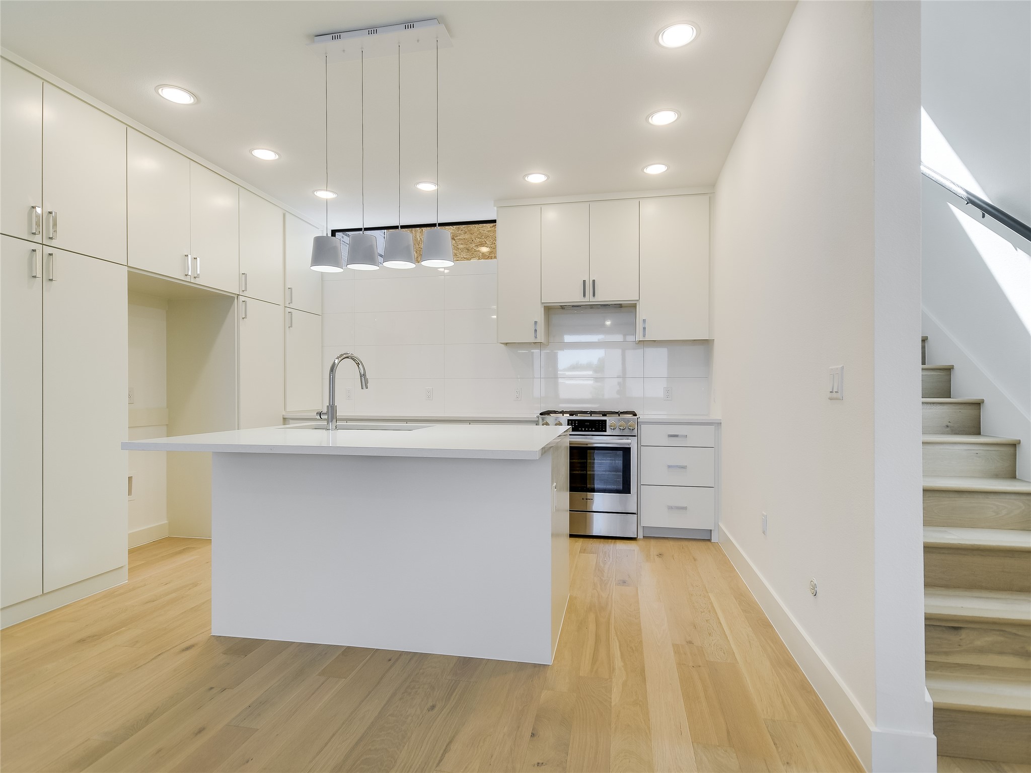 3406 East 17th Street, Unit 3 Austin, TX 78721 - Photo 14 of 27 a kitchen with kitchen island a sink appliances and cabinets
