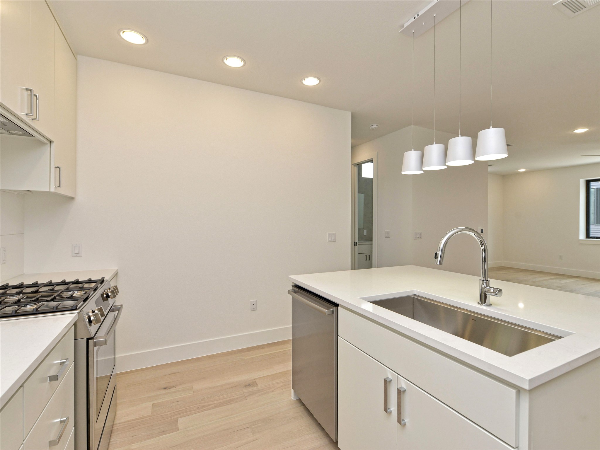 3406 East 17th Street, Unit 3 Austin, TX 78721 - Photo 15 of 27 a kitchen with a sink and a stove top oven