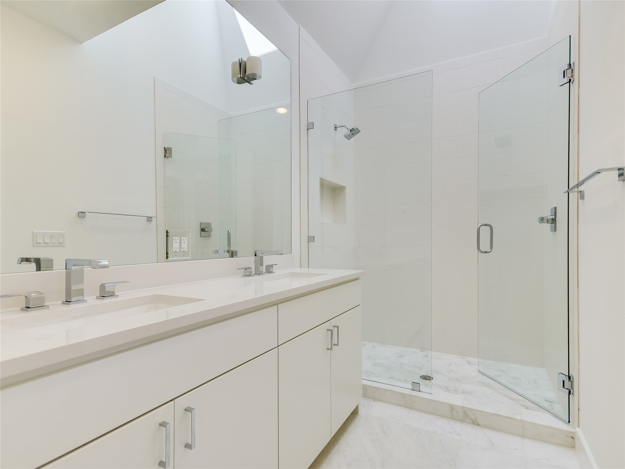 3406 East 17th Street, Unit 3 Austin, TX 78721 - Photo 18 of 27 a bathroom with a double vanity sink mirror and shower