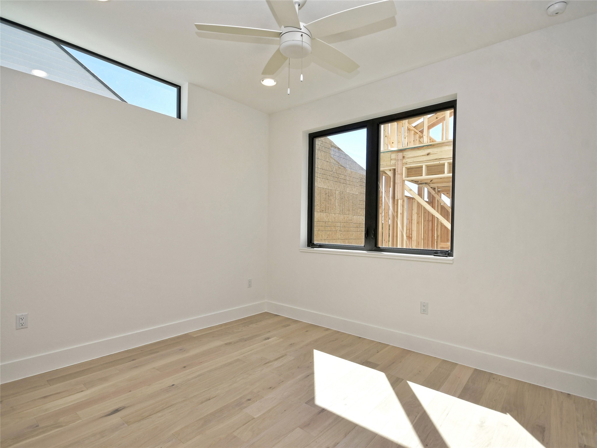 3406 East 17th Street, Unit 3 Austin, TX 78721 - Photo 20 of 27 wooden floor in an empty room with a window
