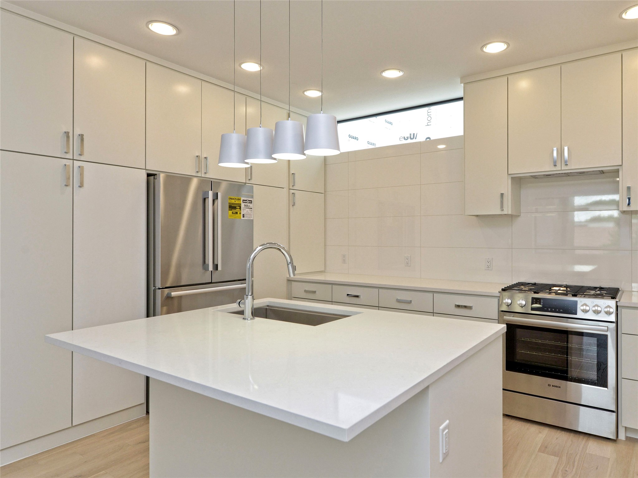3406 East 17th Street, Unit 3 Austin, TX 78721 - Photo 4 of 27 a kitchen with kitchen island a sink stainless steel appliances and cabinets