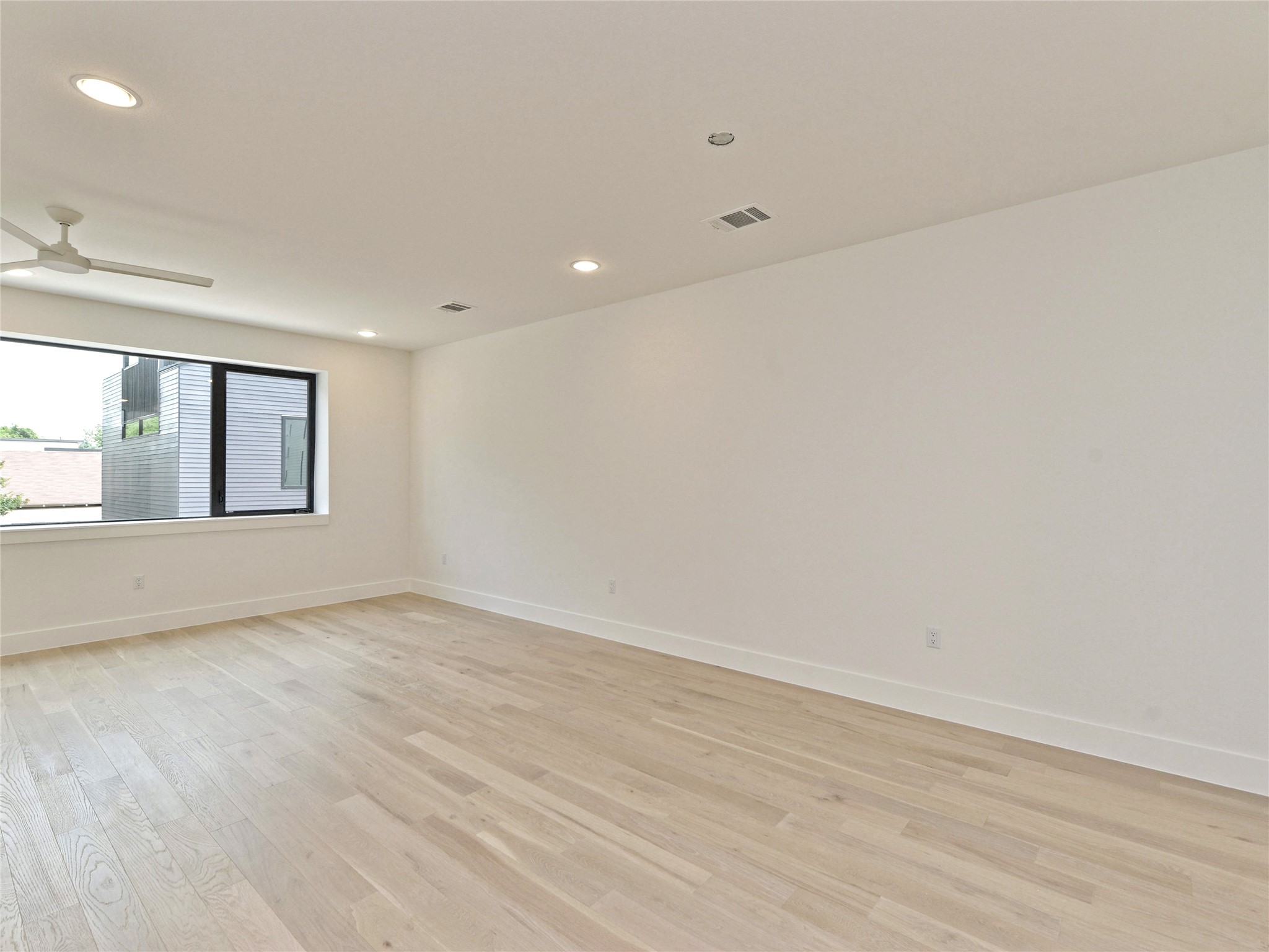 3406 East 17th Street, Unit 3 Austin, TX 78721 - Photo 10 of 27 wooden floor in an empty room with a window