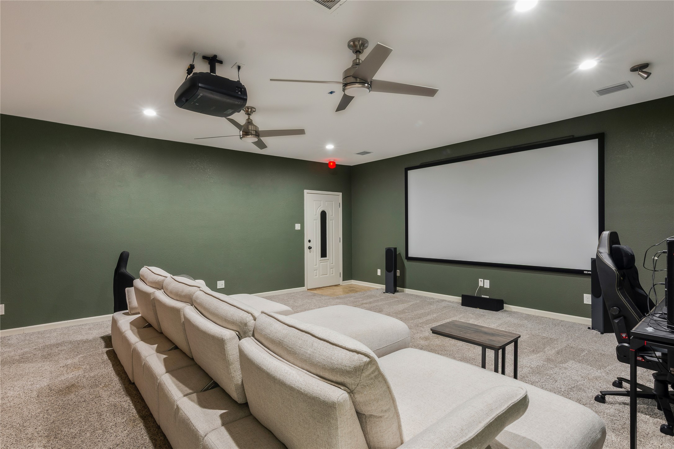13914 Skinner Road Cypress, TX 77429 - Photo 25 of 50 Dedicated media room with recessed lighting, a ceiling fan, dark accent wall, and plenty of space for theater seating.