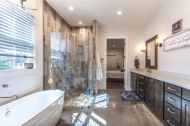 a bathroom with a granite countertop sink a toilet a mirror and shower