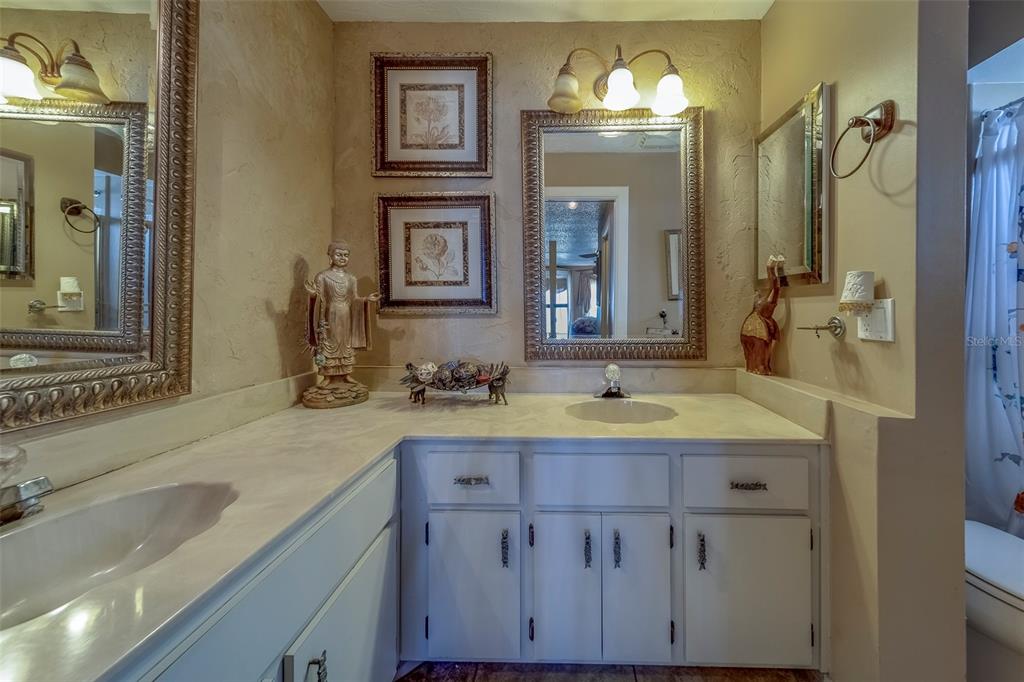 17606 Lee Avenue Redington Shores, FL 33708 - Photo 32 of 85 a bathroom with a sink and a mirror