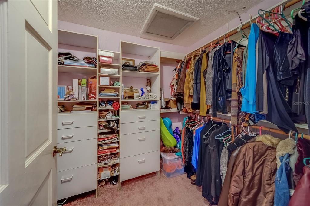 17606 Lee Avenue Redington Shores, FL 33708 - Photo 34 of 85 a view of walk in closet with clothes and shoes
