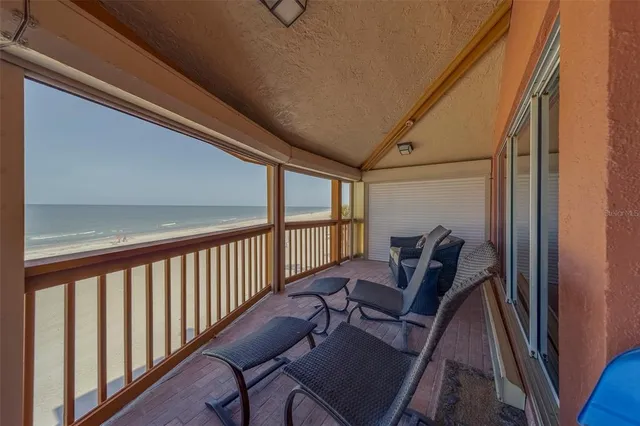 a view of a porch with wooden floor and furniture