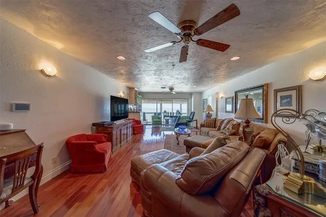 a bedroom with a bed couch chandelier and a window