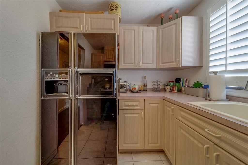 17606 Lee Avenue Redington Shores, FL 33708 - Photo 42 of 85 a kitchen with a refrigerator and cabinets