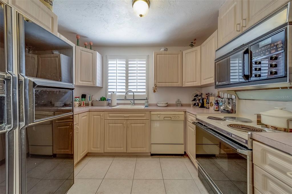 17606 Lee Avenue Redington Shores, FL 33708 - Photo 43 of 85 a kitchen with stainless steel appliances granite countertop a sink and cabinets