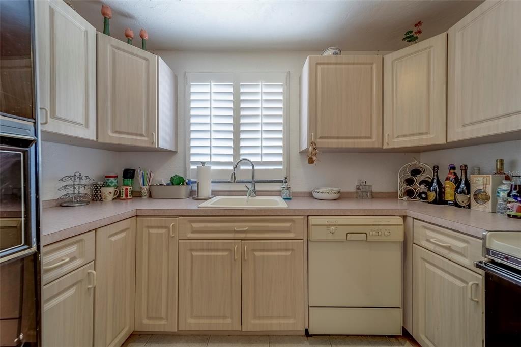 17606 Lee Avenue Redington Shores, FL 33708 - Photo 44 of 85 a kitchen with white cabinets and white appliances