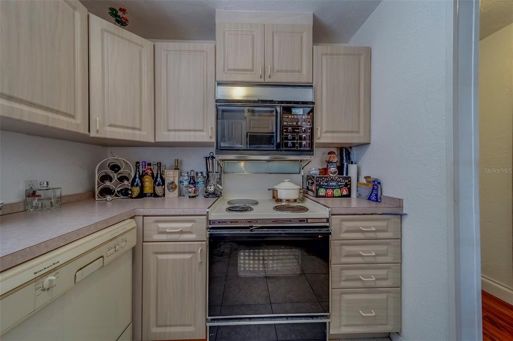 17606 Lee Avenue Redington Shores, FL 33708 - Photo 45 of 85 a kitchen with granite countertop white cabinets and stainless steel appliances