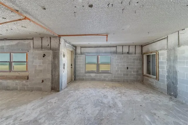 a view of a hallway with wooden floor and stairs