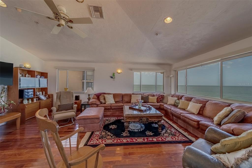 17606 Lee Avenue Redington Shores, FL 33708 - Photo 76 of 85 a living room with furniture a ceiling fan and a rug