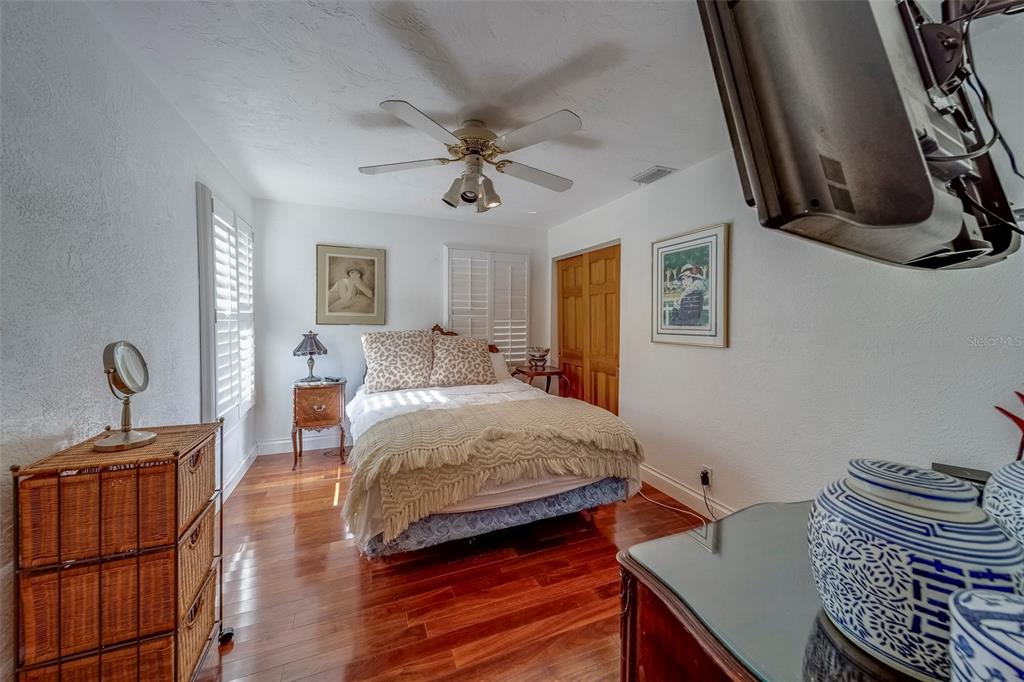 17606 Lee Avenue Redington Shores, FL 33708 - Photo 80 of 85 a bedroom with a bed and wooden floor