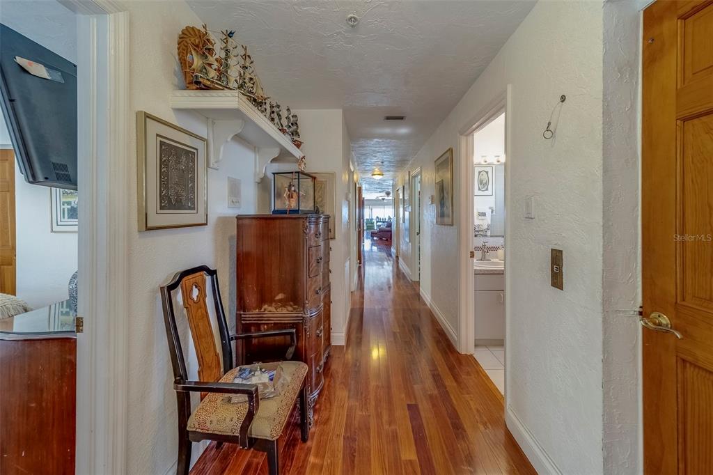 17606 Lee Avenue Redington Shores, FL 33708 - Photo 82 of 85 a view of a hallway with wooden floor and stairs