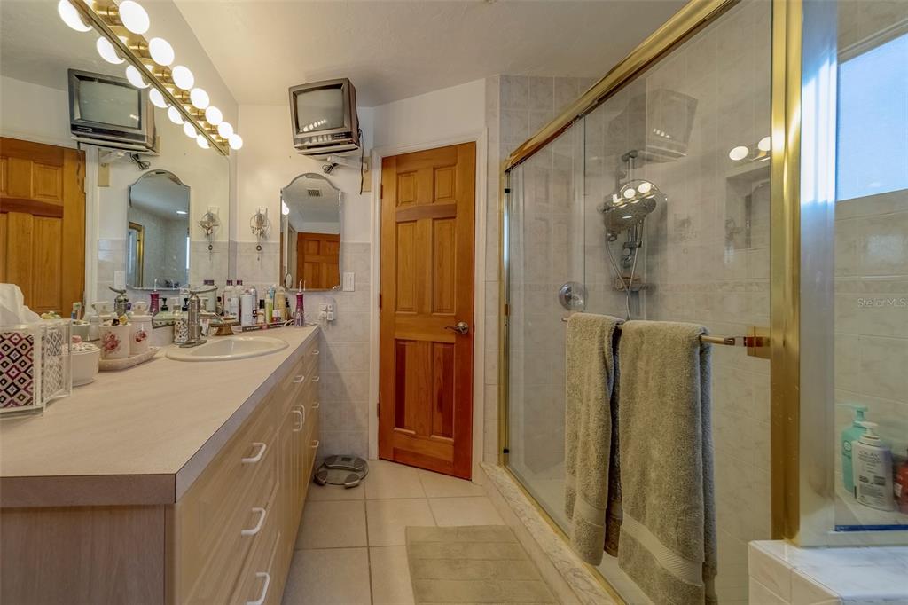 17606 Lee Avenue Redington Shores, FL 33708 - Photo 85 of 85 a bathroom with a double vanity sink a mirror and shower