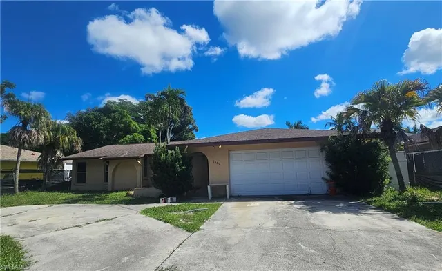 a view of a house with a yard and garage
