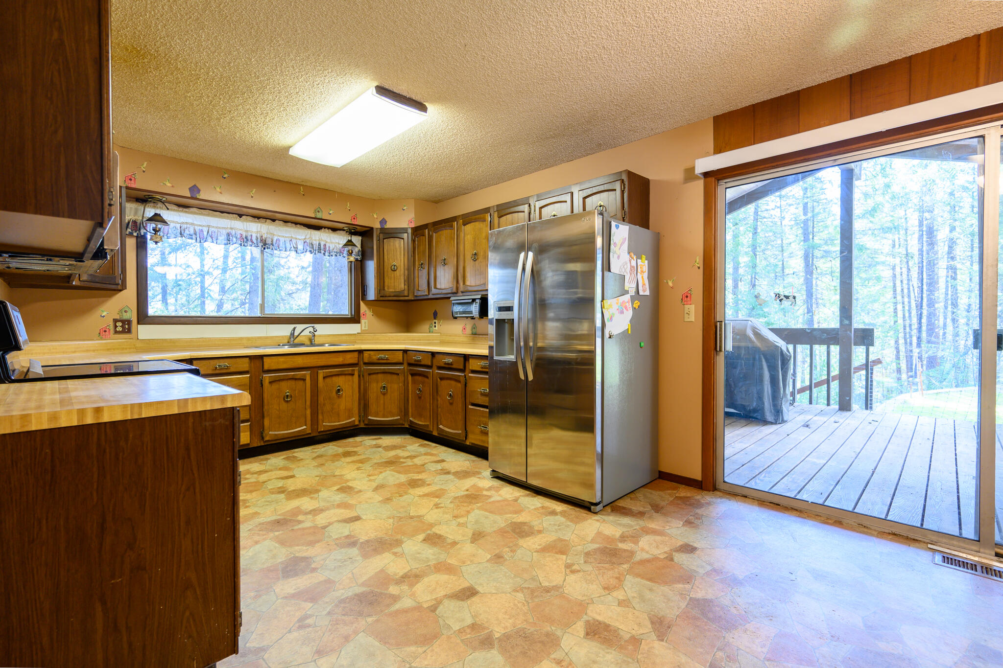 81 Swift Creek Road Trinity Center, CA 96091 - Photo 23 of 54 a kitchen with stainless steel appliances granite countertop a refrigerator a sink a stove and island