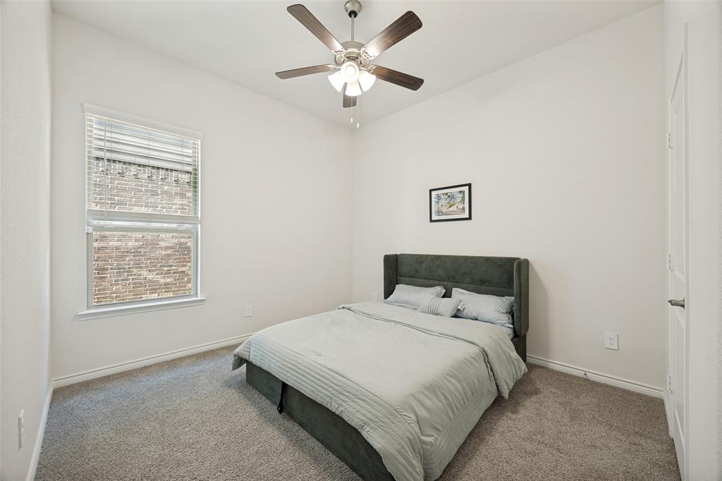 3816 Blacksmith Road Aubrey, TX 76227 - Photo 15 of 30 Carpeted flooring, vaulted ceiling, white walls, ceiling fan with light fixture, and window with blinds