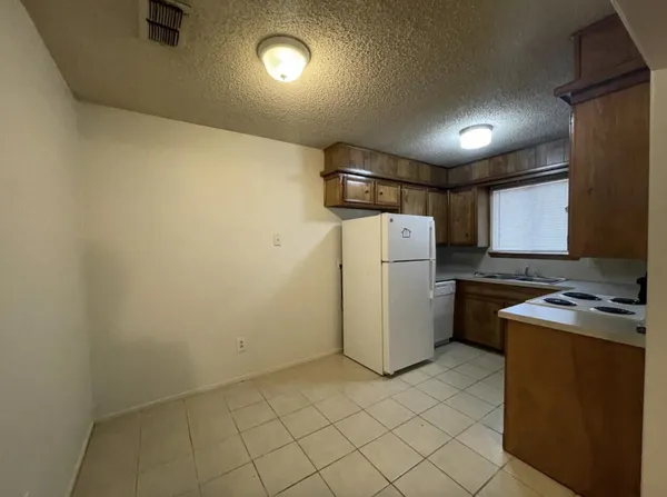 a kitchen with a stove a refrigerator and a refrigerator