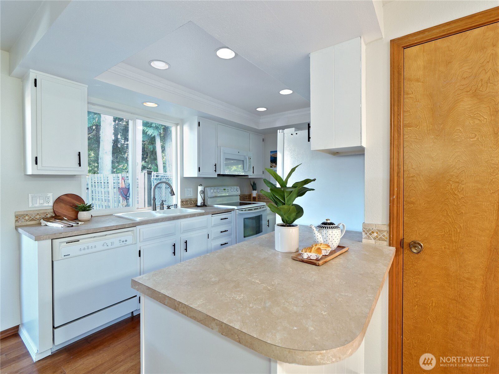 10925 Southeast 183rd Place Renton, WA 98055 - Photo 17 of 34 a kitchen with stainless steel appliances granite countertop a sink a stove and window