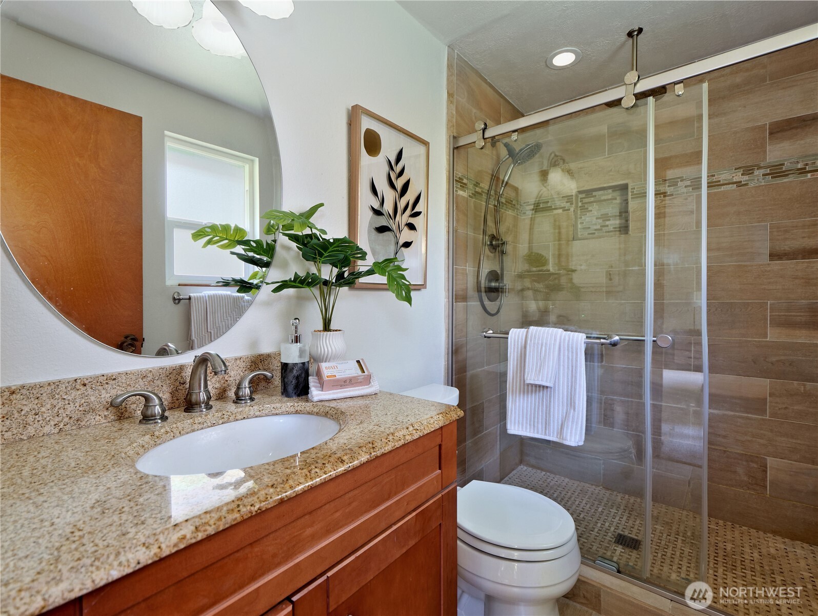 10925 Southeast 183rd Place Renton, WA 98055 - Photo 22 of 34 a bathroom with a granite countertop sink a toilet and shower