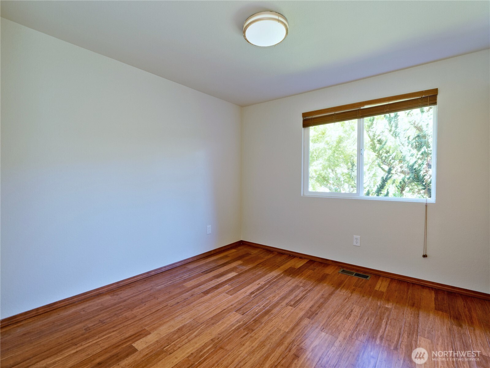 10925 Southeast 183rd Place Renton, WA 98055 - Photo 25 of 34 an empty room with wooden floor and windows