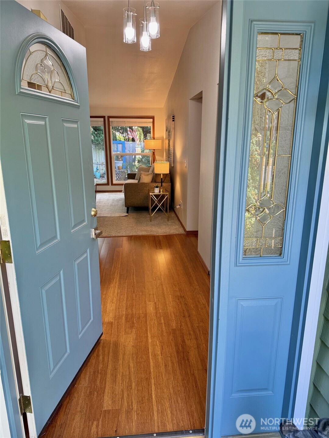 10925 Southeast 183rd Place Renton, WA 98055 - Photo 4 of 34 a view of a hallway with wooden floor fireplace and bedroom