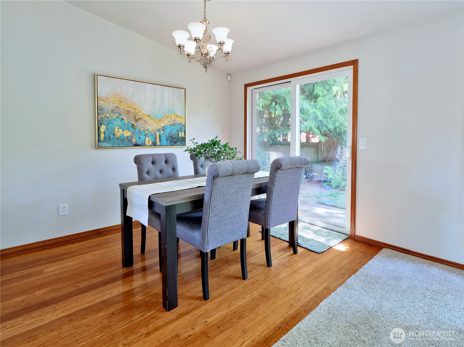 10925 Southeast 183rd Place Renton, WA 98055 - Photo 8 of 34 a view of a dining room with furniture a chandelier and wooden floor
