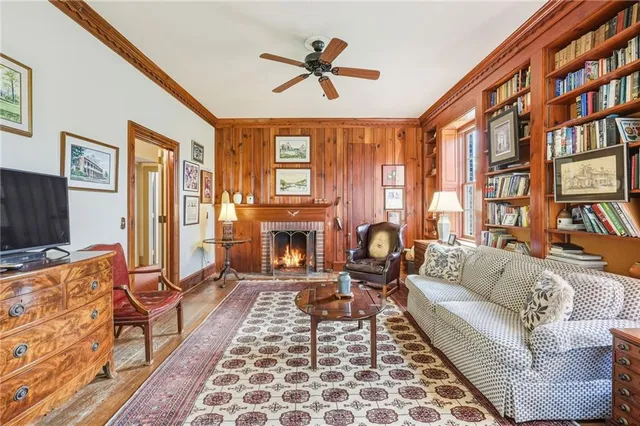 a kitchen with stainless steel appliances granite countertop a sink dishwasher a stove and a refrigerator with wooden floor